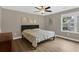 Cozy bedroom features a ceiling fan, and a large window providing ample natural light at 935 Grove Valley Drive Dr, Cumming, GA 30041