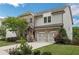 Charming two-story home featuring a blend of brick and siding, complemented by a well-manicured lawn and an attached two-car garage at 935 Grove Valley Drive Dr, Cumming, GA 30041