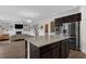 Gourmet kitchen with stainless steel appliances, large island, open to the living room at 935 Grove Valley Drive Dr, Cumming, GA 30041