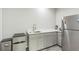 Convenient kitchenette features sleek cabinets, countertop space and modern appliances at 935 Grove Valley Drive Dr, Cumming, GA 30041