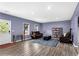 Inviting living room with hardwood floors, leather furniture, and natural light from the windows at 935 Grove Valley Drive Dr, Cumming, GA 30041