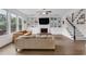 Bright and airy living room with built-in shelving, fireplace, hardwood floors and staircase at 935 Grove Valley Drive Dr, Cumming, GA 30041