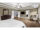 Spacious main bedroom with tray ceiling, ceiling fan, and doorway leading to an en-suite bathroom at 935 Grove Valley Drive Dr, Cumming, GA 30041