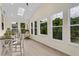 Bright sunroom featuring large windows with natural light, skylight, and wood laminate flooring at 935 Grove Valley Drive Dr, Cumming, GA 30041