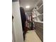 Spacious walk-in closet with custom shelving and hanging storage for clothing and accessories at 935 Grove Valley Drive Dr, Cumming, GA 30041