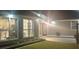 Exterior shot featuring a lighted back patio off the house with multiple windows into the home at 499 Running Doe Ct, Suwanee, GA 30024