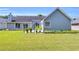Expansive backyard with lush green grass, mature trees, and meticulously maintained landscaping at 499 Running Doe Ct, Suwanee, GA 30024