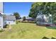 Wide backyard offers ample space, green lawn and mature trees in the landscape at 499 Running Doe Ct, Suwanee, GA 30024