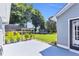Large backyard featuring a concrete patio, well-maintained lawn, and established landscaping at 499 Running Doe Ct, Suwanee, GA 30024