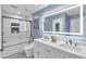 Beautiful bathroom features a modern vanity with dual sinks, sleek tile work, and a glass-enclosed shower at 499 Running Doe Ct, Suwanee, GA 30024