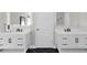 Modern bathroom featuring dual vanities with white cabinets and sleek black hardware at 499 Running Doe Ct, Suwanee, GA 30024