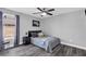 This inviting bedroom features gray walls, modern decor, ceiling fan, and a comfortable full-sized bed at 499 Running Doe Ct, Suwanee, GA 30024