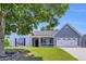 Charming home with a large, manicured front yard and a welcoming porch at 499 Running Doe Ct, Suwanee, GA 30024