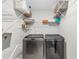Functional laundry room equipped with modern washer, dryer, and ample shelving at 499 Running Doe Ct, Suwanee, GA 30024