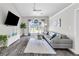 Bright living room featuring a large window and comfortable seating at 499 Running Doe Ct, Suwanee, GA 30024
