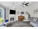 Cozy living room features a fireplace, piano, stylish decor, ceiling fan, and comfortable seating at 499 Running Doe Ct, Suwanee, GA 30024