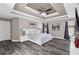 Spacious primary bedroom features a tray ceiling, ceiling fan, en-suite bathroom, and large windows at 499 Running Doe Ct, Suwanee, GA 30024