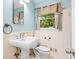 Small bathroom with blue walls, a pedestal sink, and a commode at 824 Hickory Ridge Sw Rd, Lilburn, GA 30047