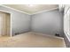 Bedroom showcasing soft carpet, baseboard heat, and natural light from the shutters at 824 Hickory Ridge Sw Rd, Lilburn, GA 30047