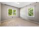 Neutrally painted bedroom with carpet and two windows providing ample natural light at 824 Hickory Ridge Sw Rd, Lilburn, GA 30047