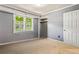 Bedroom showcasing soft carpet, baseboard heat, a closet, and natural light from the window at 824 Hickory Ridge Sw Rd, Lilburn, GA 30047