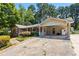 Charming single-story home featuring a large, cracked concrete driveway and carport at 824 Hickory Ridge Sw Rd, Lilburn, GA 30047