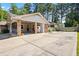 Expansive concrete driveway with backyard access and covered parking at this lovely home at 824 Hickory Ridge Sw Rd, Lilburn, GA 30047