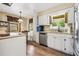 Charming kitchen featuring white cabinets, wood floor, stainless appliances and natural light at 824 Hickory Ridge Sw Rd, Lilburn, GA 30047