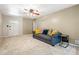 Cozy living room with neutral carpet, ceiling fan, and bright front door at 824 Hickory Ridge Sw Rd, Lilburn, GA 30047