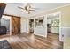 Living room features hardwood floors, a barn door, and a view into the kitchen at 824 Hickory Ridge Sw Rd, Lilburn, GA 30047
