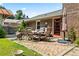 Brick patio area with outdoor seating, garden hose, and a nearby shed at 824 Hickory Ridge Sw Rd, Lilburn, GA 30047