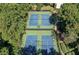 Aerial view of four outdoor tennis courts surrounded by mature trees and shrubbery at 22 Dunwoody Springs Dr, Atlanta, GA 30328