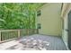 Elevated wooden back deck provides tranquil views of the surrounding trees and yard at 22 Dunwoody Springs Dr, Atlanta, GA 30328