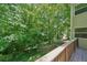 Wooden deck showcasing a green, tree-filled backyard, inviting nature and shade at 22 Dunwoody Springs Dr, Atlanta, GA 30328