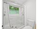 Bathroom with glass-enclosed shower and tub combo and updated fixtures at 22 Dunwoody Springs Dr, Atlanta, GA 30328