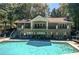 Large building featuring a swimming pool with sundeck, mature trees and beautiful exterior facade at 22 Dunwoody Springs Dr, Atlanta, GA 30328