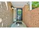 Close-up of a black front door with glass detailing, set against a brick exterior and concrete path at 22 Dunwoody Springs Dr, Atlanta, GA 30328