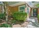 Charming brick facade, lush green bushes, and a black front door create an inviting entrance at 22 Dunwoody Springs Dr, Atlanta, GA 30328