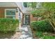 Inviting brick townhome entrance featuring a black door, lush green bushes, and a brick facade at 22 Dunwoody Springs Dr, Atlanta, GA 30328