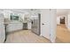 Bright kitchen features stainless steel refrigerator and access to the front entryway at 22 Dunwoody Springs Dr, Atlanta, GA 30328