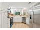 Updated kitchen with stainless steel appliances, white cabinets, and window over sink at 22 Dunwoody Springs Dr, Atlanta, GA 30328