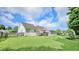 Spacious backyard with a mix of lawn, wooden fence, potted plants, and a view of the back of the home at 2233 Hansford Pass, Buford, GA 30519