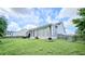 Well-maintained backyard with a sunroom-style extension, wooden fencing, and green grass at 2233 Hansford Pass, Buford, GA 30519