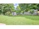 Large grassy backyard featuring a storage shed and a well-maintained wooden fence for privacy at 2233 Hansford Pass, Buford, GA 30519