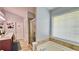 Bathroom features dual sinks, soaking tub, walk-in shower, and neutral tile at 2233 Hansford Pass, Buford, GA 30519