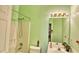 Bathroom with shower-tub combination, sink and bright green walls at 2233 Hansford Pass, Buford, GA 30519