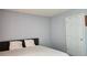 This bedroom features neutral colored walls, a bed with a headboard, and a white door at 2233 Hansford Pass, Buford, GA 30519