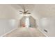 Expansive bonus room or flex space with neutral carpeting and ceiling fan at 2233 Hansford Pass, Buford, GA 30519