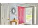 Entryway with a decorative mirror, wooden table, colorful door and storm door, creating a welcoming atmosphere at 2233 Hansford Pass, Buford, GA 30519