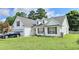 Inviting home with a lush lawn, dormer windows, and a black SUV parked in the driveway, showing curb appeal at 2233 Hansford Pass, Buford, GA 30519